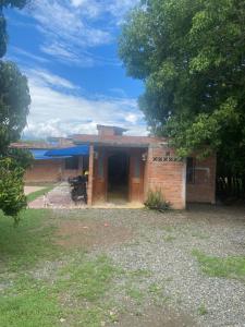 a small brick house with a large door at Santa Fe hostal in Santa Fe de Antioquia