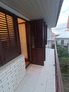 a balcony of a house with a wooden door at Lake and Forrest in Belgrade