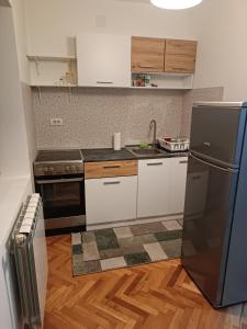 a kitchen with white cabinets and a black refrigerator at Lake and Forrest in Belgrade