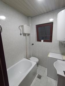 a bathroom with a tub and a toilet and a sink at Lake and Forrest in Belgrade +8 photos