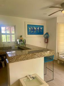a kitchen with a granite counter top and a table at Isla Lorens in Isla Mujeres