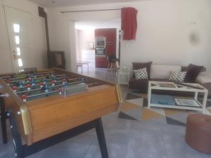 a living room with a pool table and a couch at Les LYS in Locronan