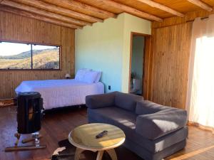a living room with a couch and a bed at Cloud Valley in Bom Jardim da Serra