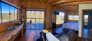 a living room with a couch and a bed and windows at Cloud Valley in Bom Jardim da Serra +21 photos