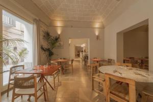 a restaurant with tables and chairs in a room at Albergo Egadi in Favignana