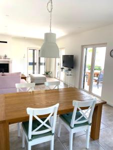 a dining room and living room with a table and chairs at Baltimore.House in Baška Voda