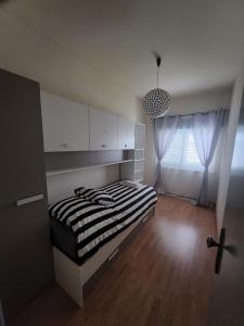 a bedroom with a bed with a black and white stripes at A Romãzeira in Torre de Moncorvo