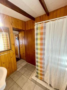 a bathroom with a shower with a shower curtain at Hostal Boutique CUMBRES in Farellones +64 photos