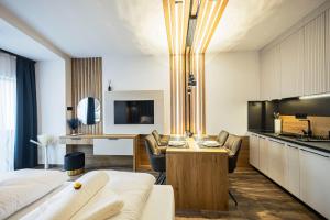 a hotel room with a kitchen and a living room at ELYX Home Apartmanok in Sárvár
