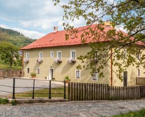 a house with a red roof and a fence at Frauenberg Villa in Banská Štiavnica