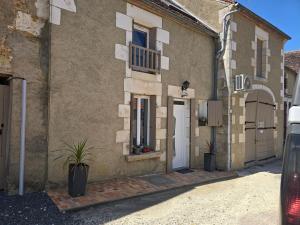 a building with a white door and a balcony at Gîte entre vigne et loire Sancerre Amigny in Sancerre