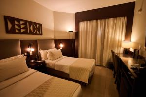 a hotel room with two beds and a window at Royal Collection Paulista in São Paulo +63 photos