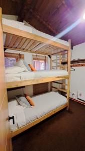 two bunk beds in a small room with at Hostal Boutique CUMBRES in Farellones