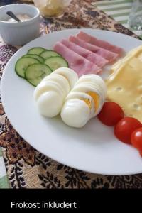a plate of food with eggs and vegetables on a table at Casa Peaceful in Mysen