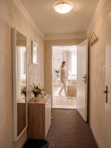 a woman walking into a room with a bathroom at Frauenberg Villa in Banská Štiavnica +122 photos