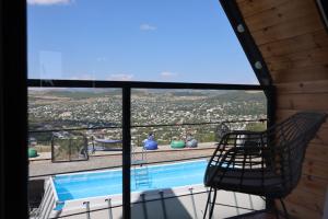 a view of a swimming pool from a house at Gemini Cottage in Dusheti in Dushetʼi