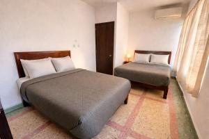 a hotel room with two beds and a window at Hotel Ripoll Córdoba in Córdoba