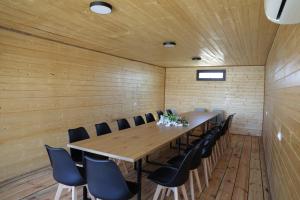 a conference room with a long wooden table and chairs at Gemini Cottage in Dusheti in Dushetʼi +56 photos