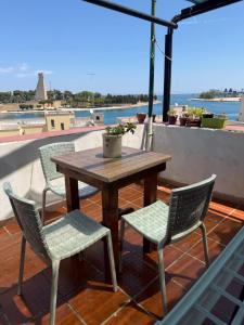 a wooden table and two chairs and a table and chairs at L'atmosfera in Brindisi