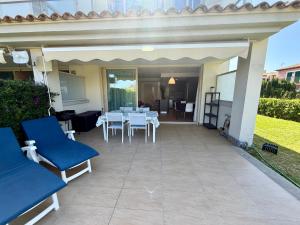a patio with a white table and chairs at Villa Dulce in Port d'Alcudia