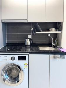 a kitchen with a washing machine and a sink at Yangyang Surfing Beach 19 in Saetchak +6 photos