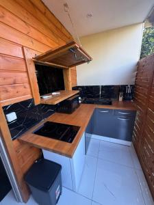 a kitchen with a counter and a stove in it at Love room Coconut Secret in Le Gosier