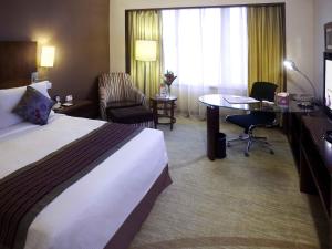 a hotel room with a bed and a desk at Grand Mercure Beijing Central in Beijing
