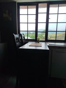 a room with a table and chairs and windows at Apartaestudio confortable 1 en Combia in Pereira +5 photos