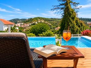 a table with a book and a glass of wine at San Georgio Hotel in Agios Georgios Pagon +36 photos