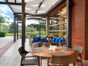 an outdoor patio with a wooden table and chairs at Novotel Trabzon in Trabzon