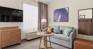 a living room with a couch and a table at Best Western PLUS Hannaford Inn & Suites in Cincinnati