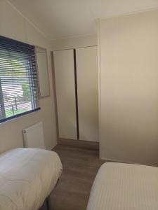 a small bedroom with a bed and a window at Wima Chalet in Sevenum
