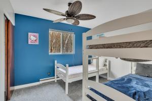a bedroom with two bunk beds and a blue wall at Luxury Mountain Villa - 3 bedroom, hot-tub, fire-pit in Hunter +32 photos