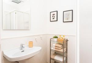 a white bathroom with a sink and a mirror at Antonio's House in Sitges +47 photos