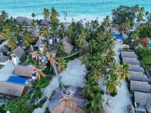 an aerial view of a resort with palm trees and the ocean at MONEA The Nest in Paje
