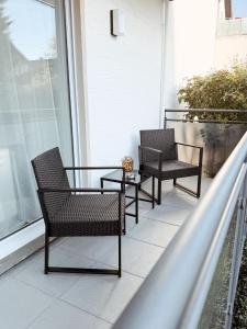 two chairs and a table on a balcony at FeWo Reimer in Horn-Bad Meinberg