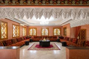 a large room with couches and a chandelier at Villa privée, 5 suites, Piscine & Jardin XXL in Marrakesh