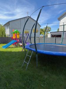 a blue trampoline in a yard with a playground at Villa Rowena in Rowy