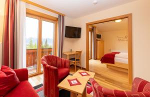 a hotel room with a view of a bedroom at Aparthotel Ramsau in Ramsau am Dachstein