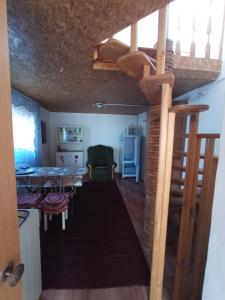 a room with a loft bed and a dining room at Домики ШАХ in Borovoye
