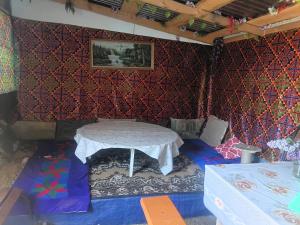 a room with a table in the corner of a wall at Домики ШАХ in Borovoye