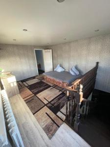 a bedroom with a bed in the middle of a room at Домики ШАХ in Borovoye