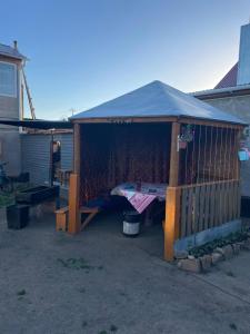 a house with a porch with a tent at Домики ШАХ in Borovoye +12 photos
