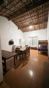 a dining room with a wooden table and chairs at Casa temporada Ilha Comprida 350m da praia in Ilha Comprida