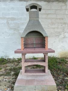 a brick oven sitting next to a wall at Casa Broglia in Castel Santa Maria