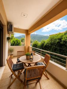 a patio with a table and chairs on a balcony at Studios Galini Porto Koufo in Porto Koufo