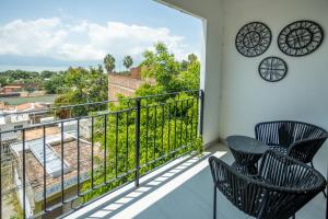 a balcony with two chairs and a view of the city at Suites Santa Isabella in Ajijic