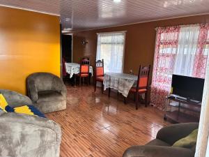 a living room with a table and chairs at Golden Jungle Hideaway in Salado