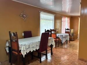a dining room with two tables and chairs and a dining room at Golden Jungle Hideaway in Salado