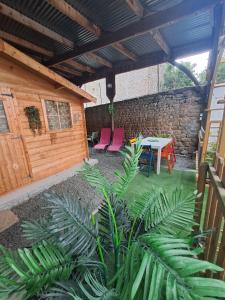 a patio with a table and chairs and a stone wall at Gîte l'escapade in Crozant